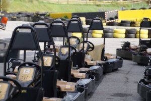 Des karting noirs alignés sur piste, prêts à être pilotés